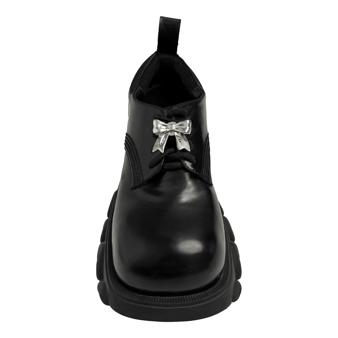 A silver metallic bow knot shoelace charm with a polished finish, adding a stylish and elegant accent to sneakers.