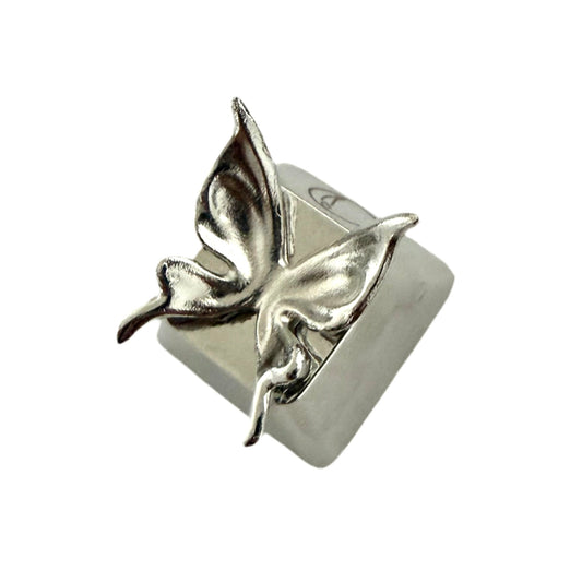 Close-up of a black keyboard with a decorative keycap featuring a silver insect design.
