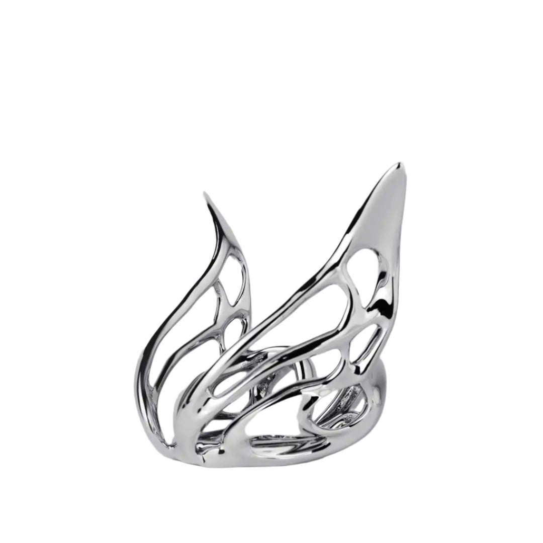 Futuristic chrome butterfly candle holder with wing-inspired curved frame – sculptural metallic design encasing a pillar candle