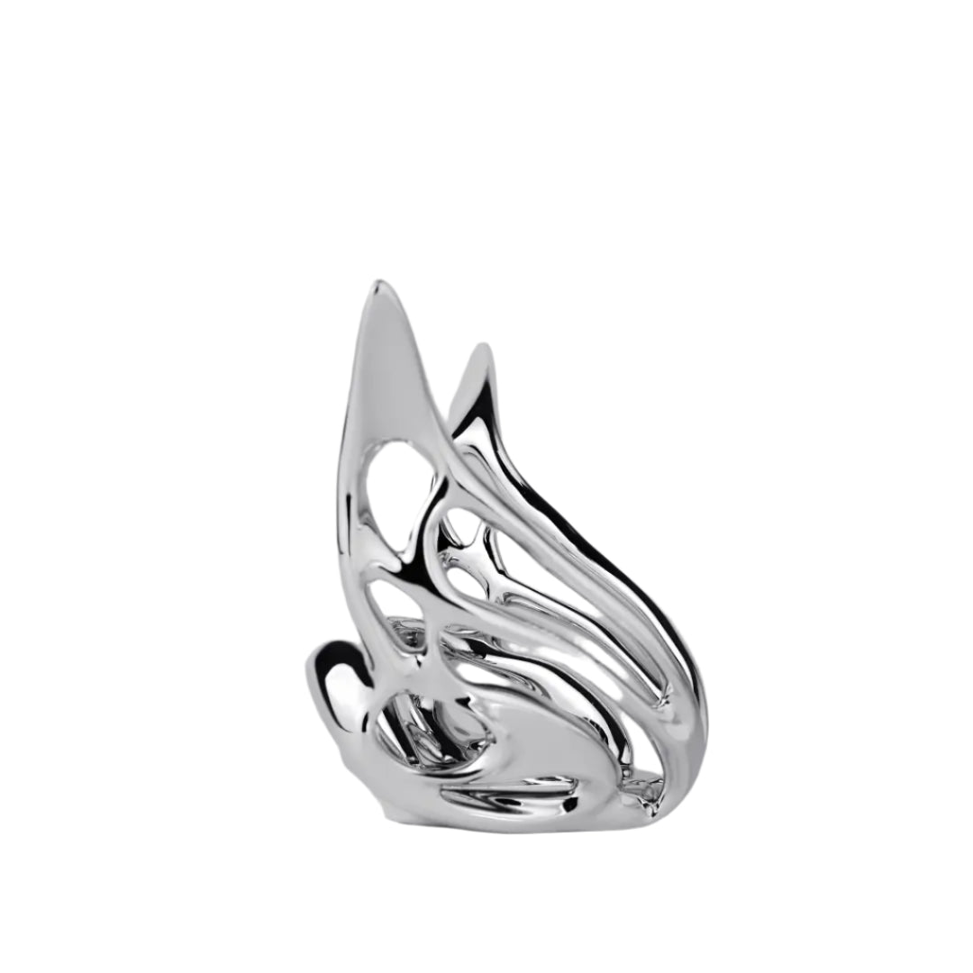 Futuristic chrome butterfly candle holder with wing-inspired curved frame – sculptural metallic design encasing a pillar candle