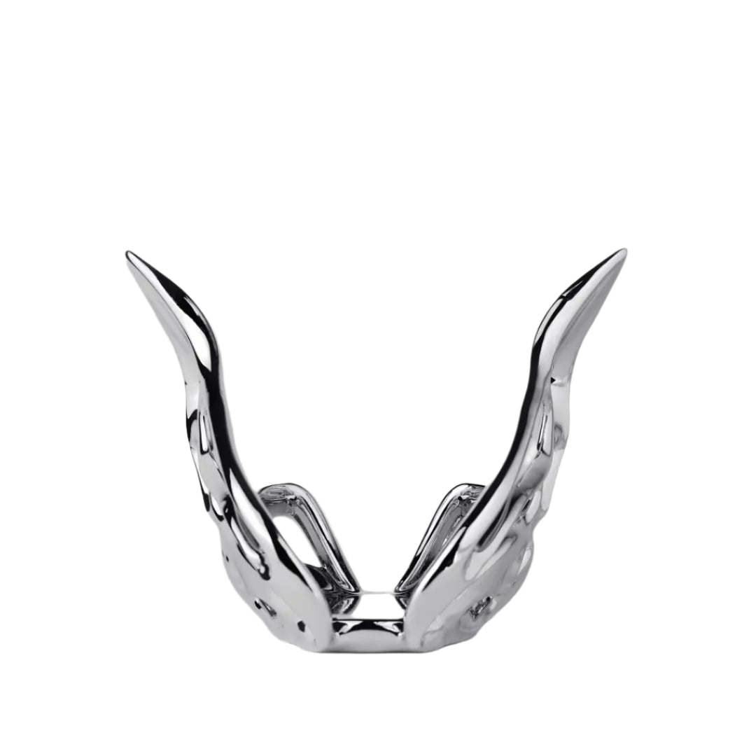 Futuristic chrome butterfly candle holder with wing-inspired curved frame – sculptural metallic design encasing a pillar candle