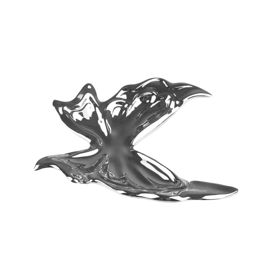 Futuristic chrome butterfly sculpture with fluid 3D wings – minimalist metal art piece featuring mirror-like surface and organic totemic form
