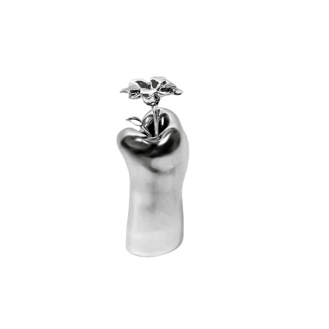 Futuristic chrome cat paw vase – sculptural paw-shaped metal vessel with smooth reflective finish, blending playful animal motif and minimalist design