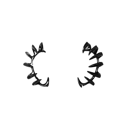 Claw Ear Cuffs — claw-shaped ear cuffs encircling the ear with sleek, sculptural curves, available in black and silver.