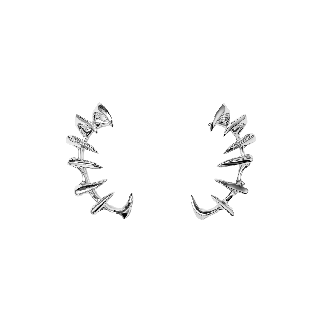 Claw Ear Cuffs — claw-shaped ear cuffs encircling the ear with sleek, sculptural curves, available in black and silver.