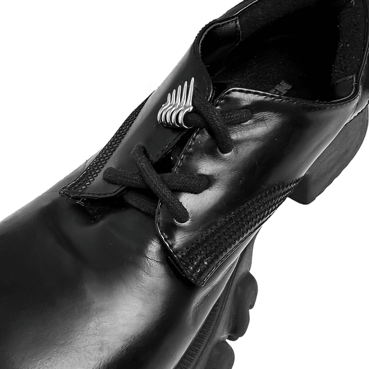 A metallic shoelace charm featuring claw-like spikes with looped rings, designed to slide onto shoelaces for a bold and edgy look.