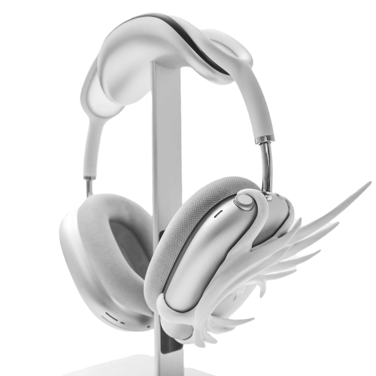 A sculptural 3D attachment for AirPods Max headphones featuring unique, upward-curled angel wings with layered feather details. Available in two finishes: Reflective Silver Chrome and Matte Ethereal White. Shown in both single ear cup and symmetrical pair configurations.