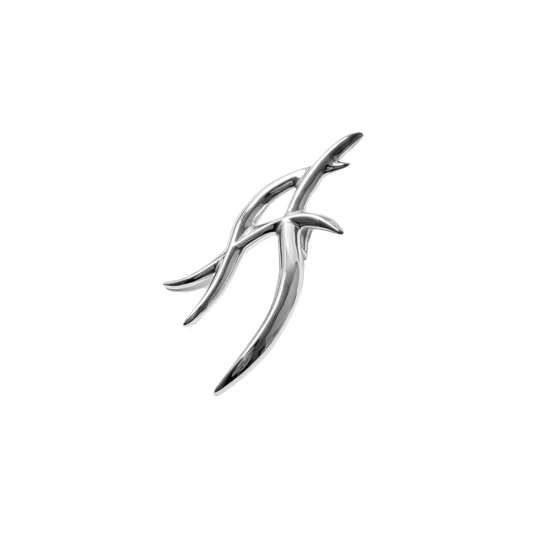 The XTENDED iDENTiTY "Cyber Dreams" Shoelry from the Cyber Dream series. A single-piece ornament featuring a fluid, abstract metallic design resembling a sharp, futuristic letter or symbol. Available finishes include Shadow Black, Liquid Silver, and Molten Gold, displayed together.