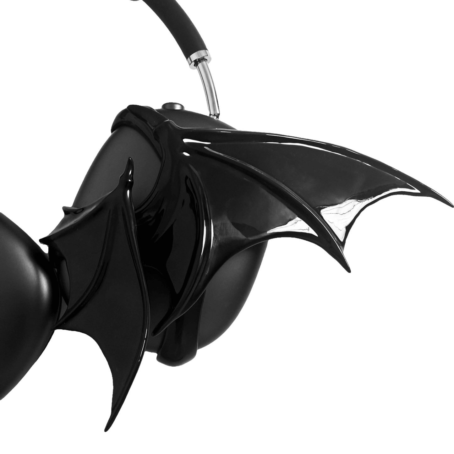 A high-fashion 3D attachment for AirPods Max headphones featuring sharp, sculpted demon wings. Available in two finishes: a high-shine Reflective Silver Chrome and a sleek Obsidian Black. The design is shown as both a single asymmetrical attachment and a symmetrical pair wrapping around the headphone ear cups.
