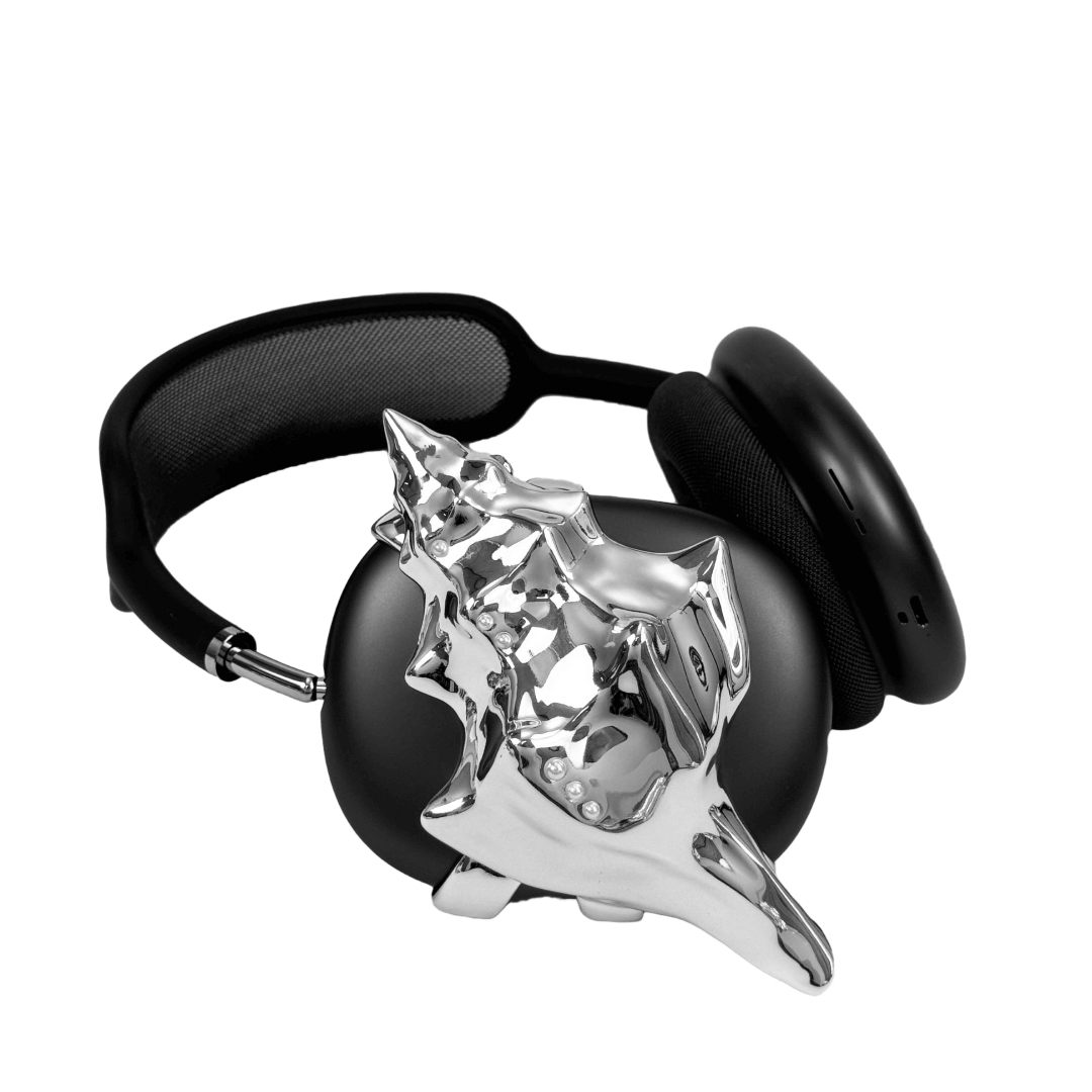 Over-ear headphones with sculptural conch shell embellishments and metallic accent dots, evoking deep-sea elegance and organic rhythm.
