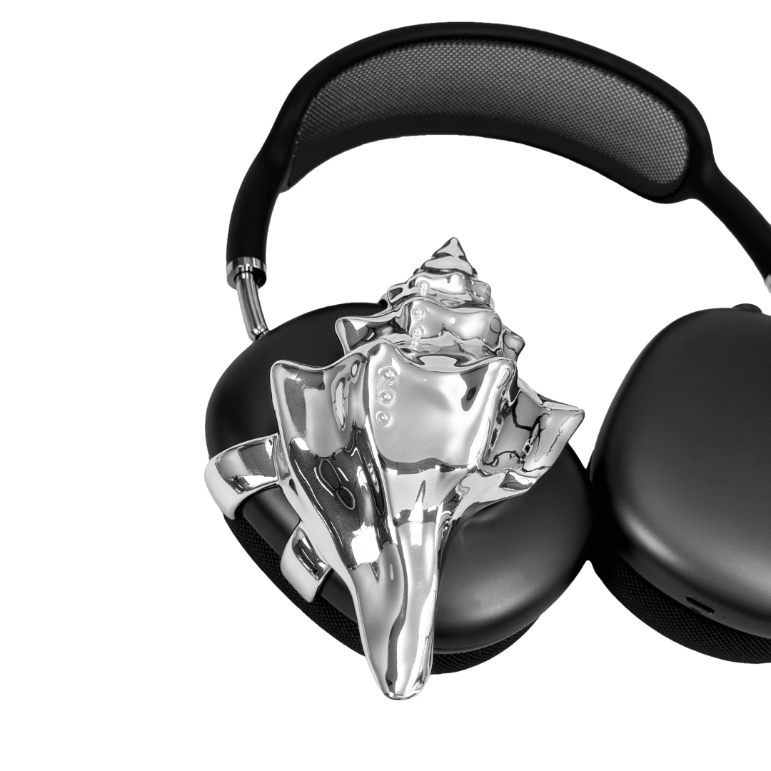 Over-ear headphones with sculptural conch shell embellishments and metallic accent dots, evoking deep-sea elegance and organic rhythm.