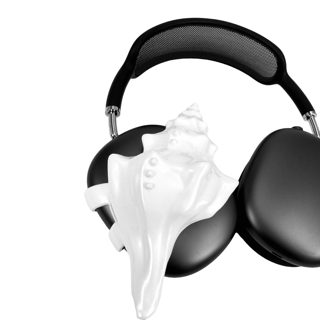 Over-ear headphones with sculptural conch shell embellishments and metallic accent dots, evoking deep-sea elegance and organic rhythm.