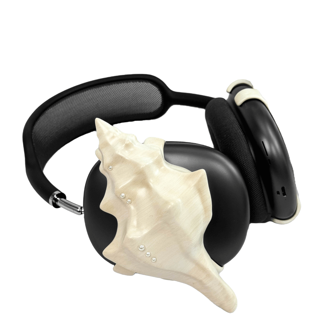 Over-ear headphones with sculptural conch shell embellishments and metallic accent dots, evoking deep-sea elegance and organic rhythm.
