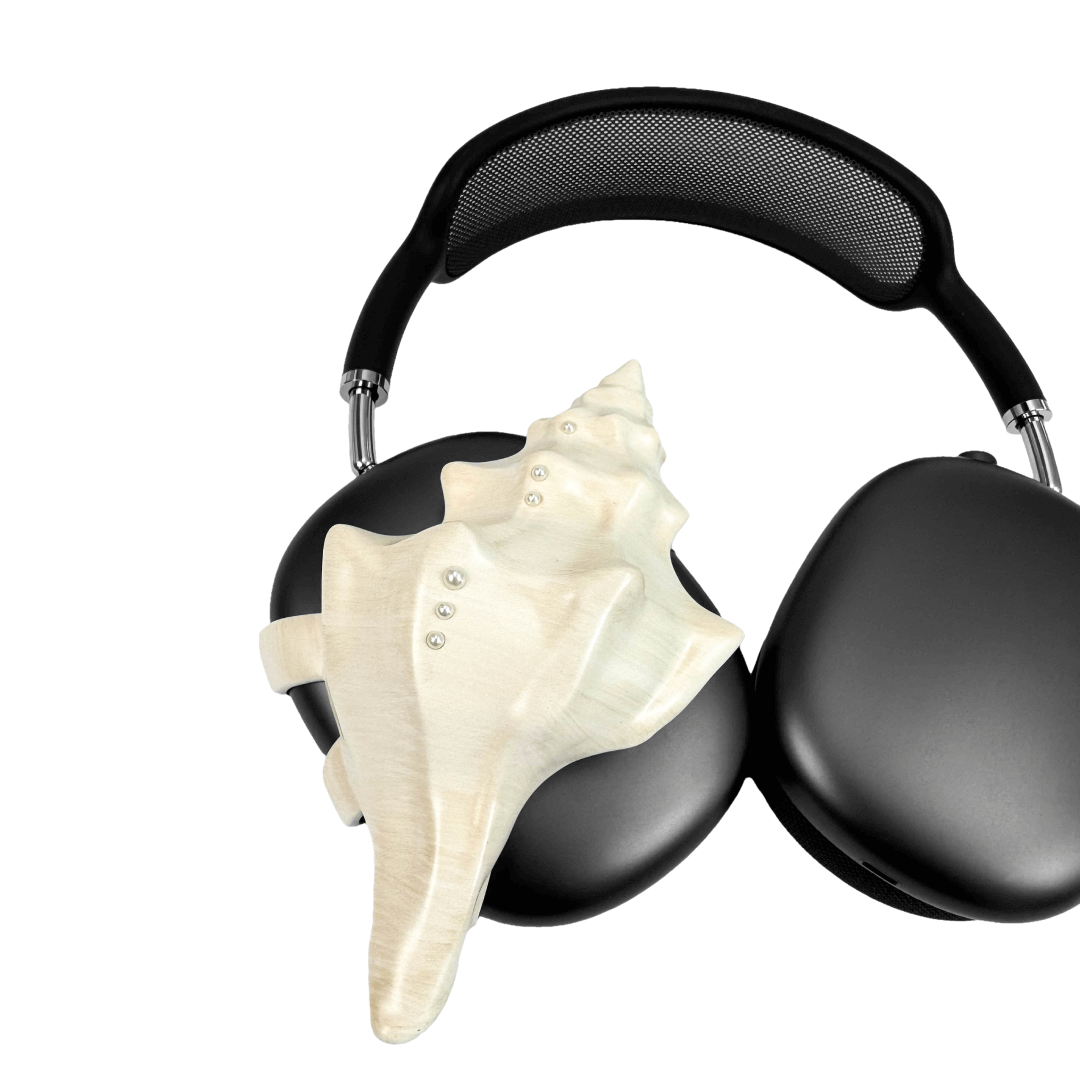 Over-ear headphones with sculptural conch shell embellishments and metallic accent dots, evoking deep-sea elegance and organic rhythm.