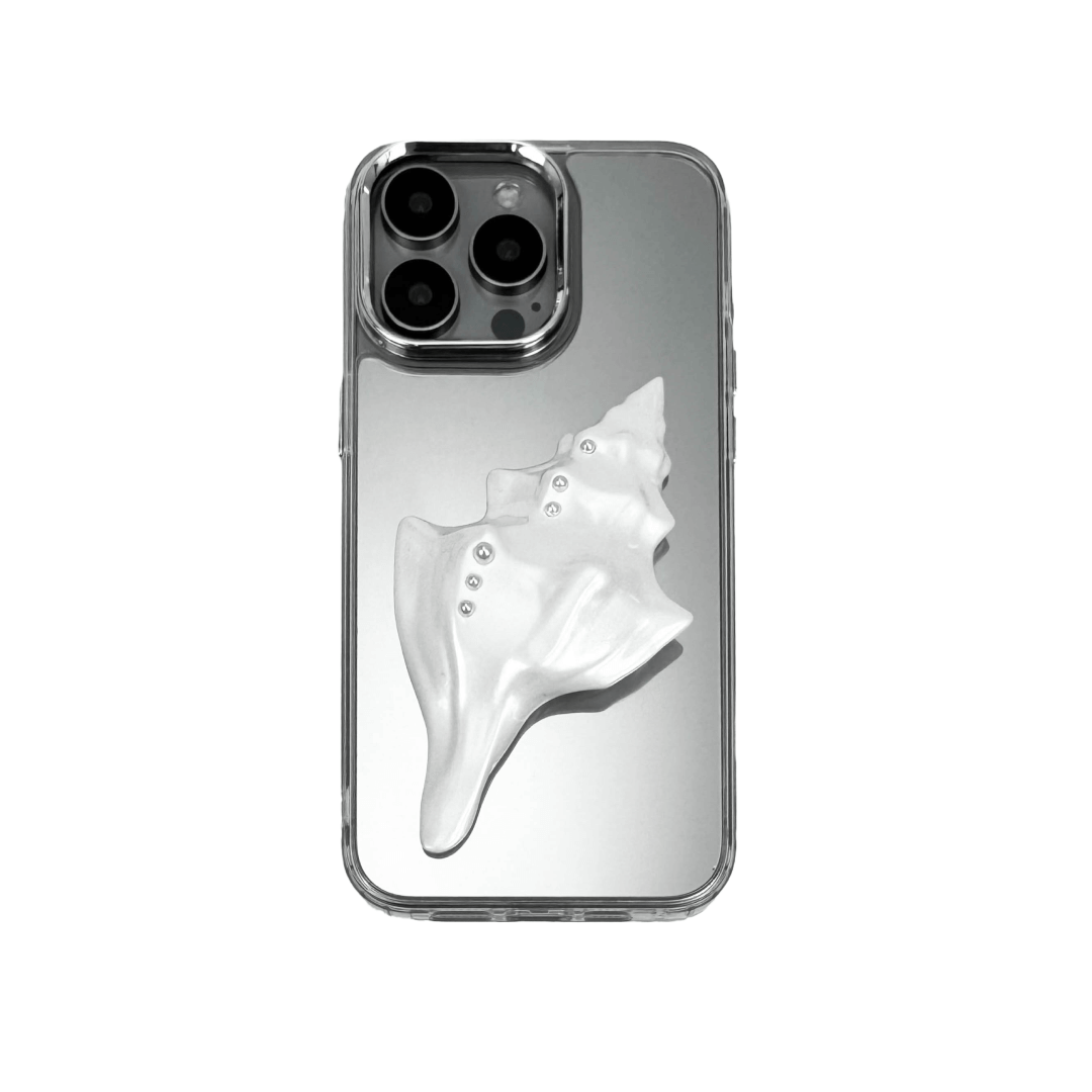 Metallic seashell-shaped phone case accessory with a sculpted, fluid spiral design and delicate pearl-like embellishments.