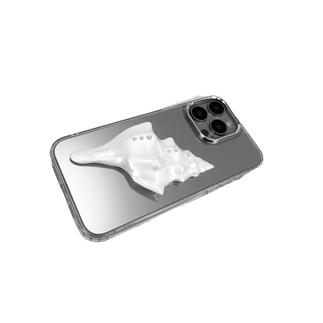 Metallic seashell-shaped phone case accessory with a sculpted, fluid spiral design and delicate pearl-like embellishments.