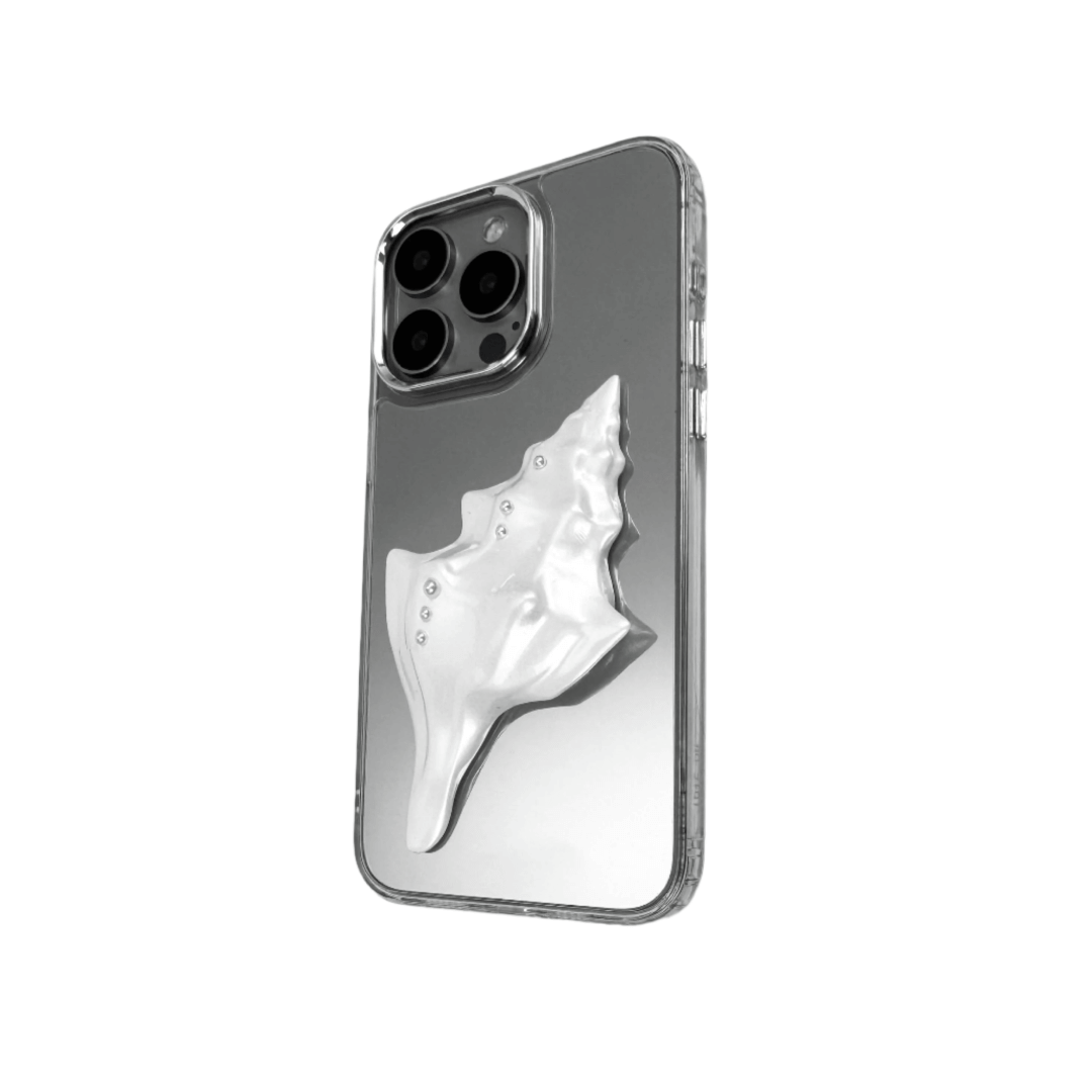 Metallic seashell-shaped phone case accessory with a sculpted, fluid spiral design and delicate pearl-like embellishments.