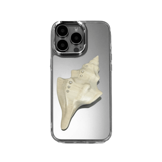 Metallic seashell-shaped phone case accessory with a sculpted, fluid spiral design and delicate pearl-like embellishments.