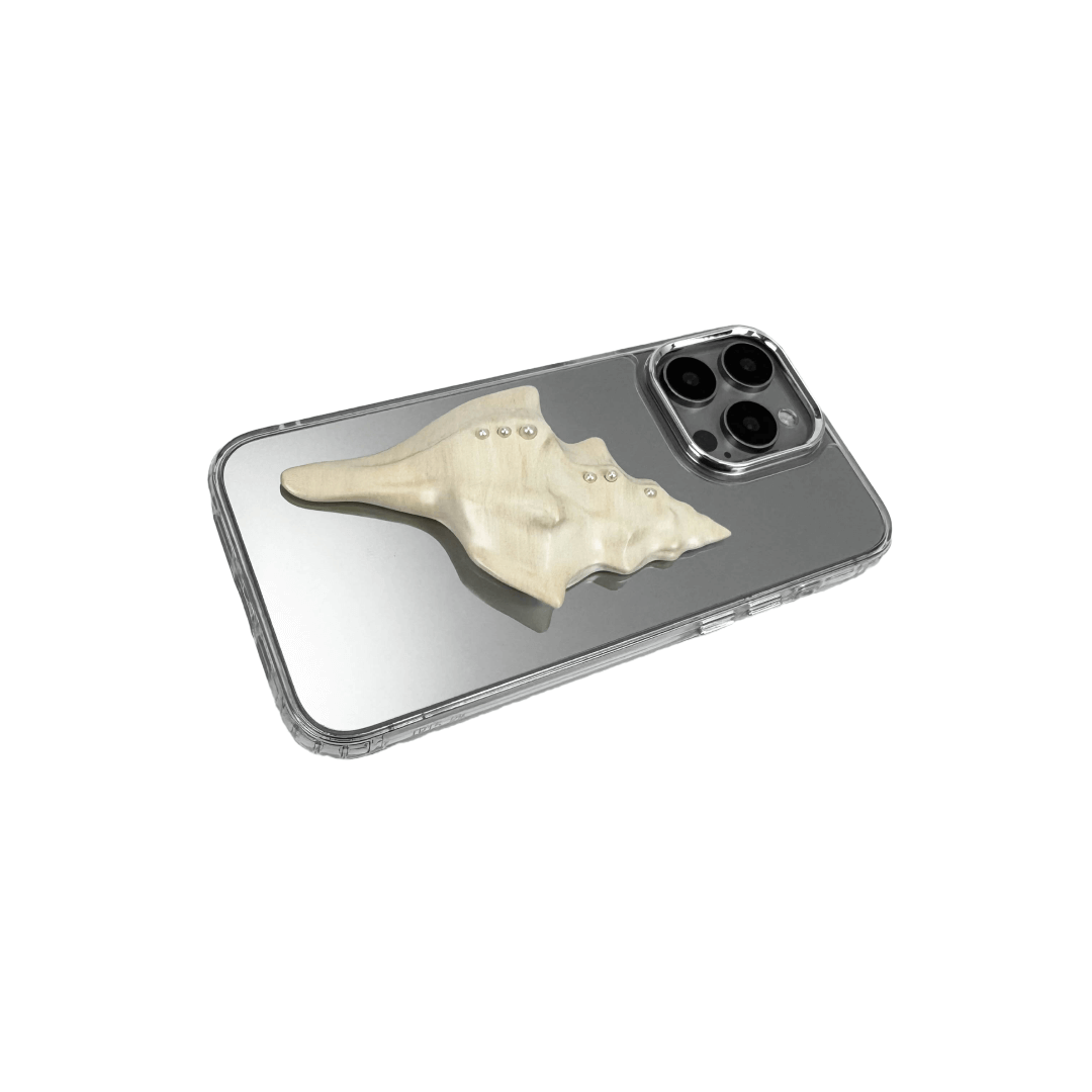 Metallic seashell-shaped phone case accessory with a sculpted, fluid spiral design and delicate pearl-like embellishments.