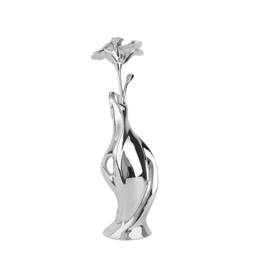 Futuristic silver vase with fluid sculptural form and blooming lily – sleek metallic design blending natural elegance and modern artistry