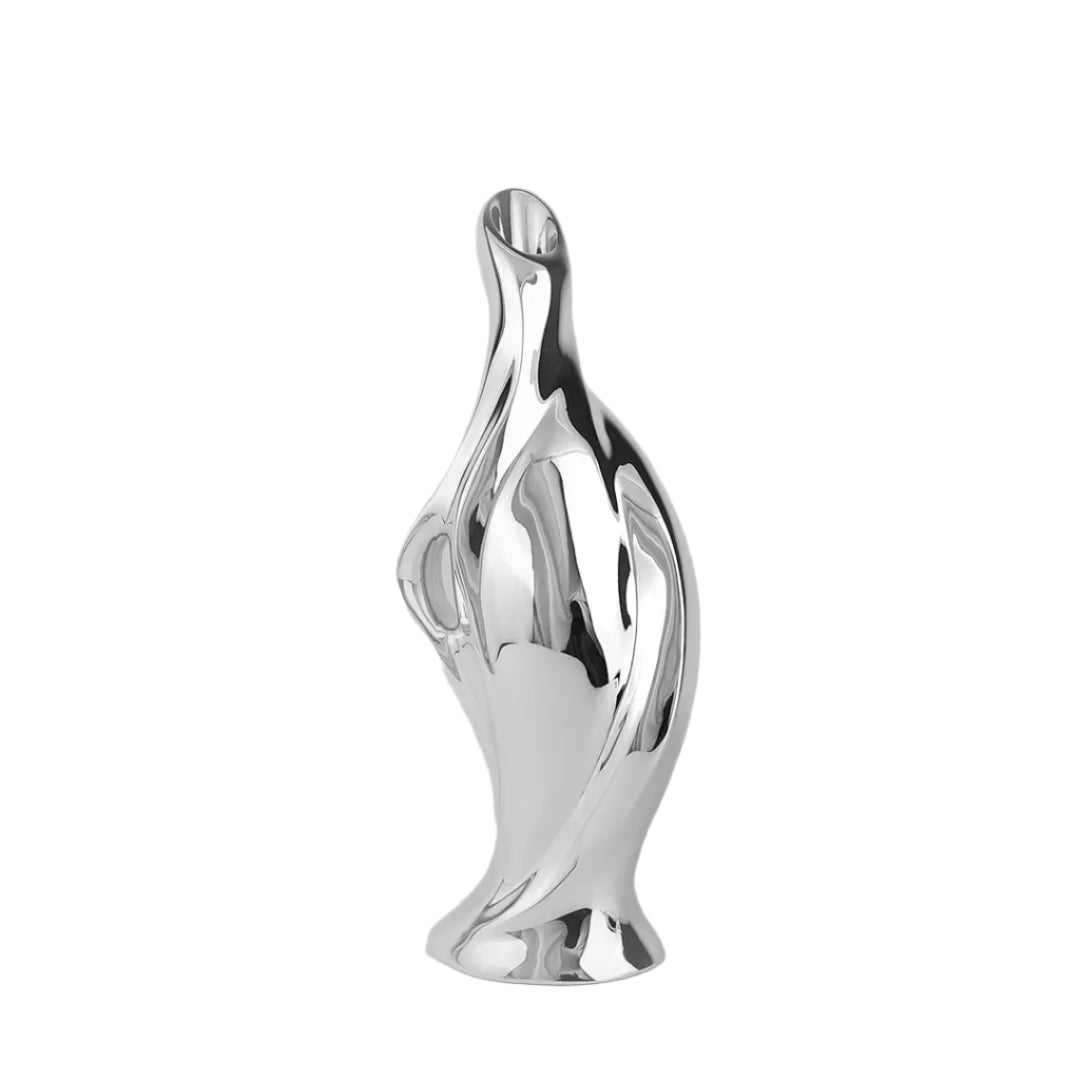 Futuristic silver vase with fluid sculptural form and blooming lily – sleek metallic design blending natural elegance and modern artistry
