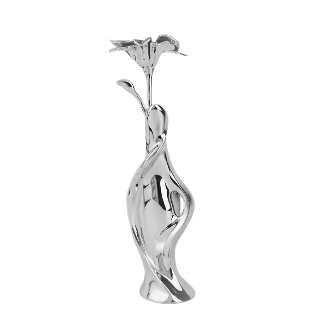 Futuristic silver vase with fluid sculptural form and blooming lily – sleek metallic design blending natural elegance and modern artistry