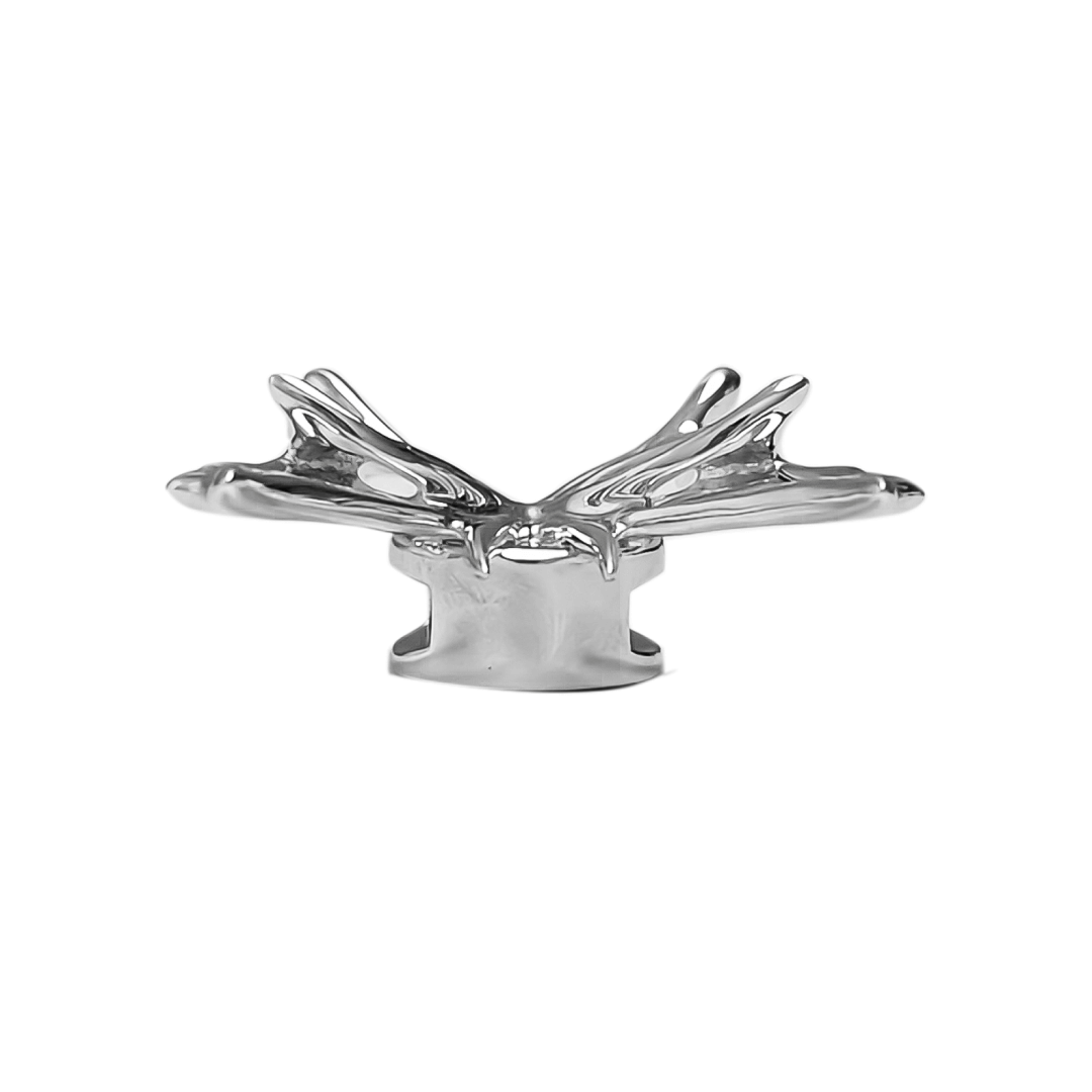 A silver metallic filigree butterfly shoelace charm with intricate openwork details, adding elegance and a luxurious accent to sneakers.