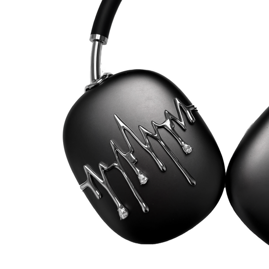 AirPods Max cover featuring silver chrome waveform patterns resembling musical pulses, with crystal-like droplets hanging from the lines, set against matte black earcups.