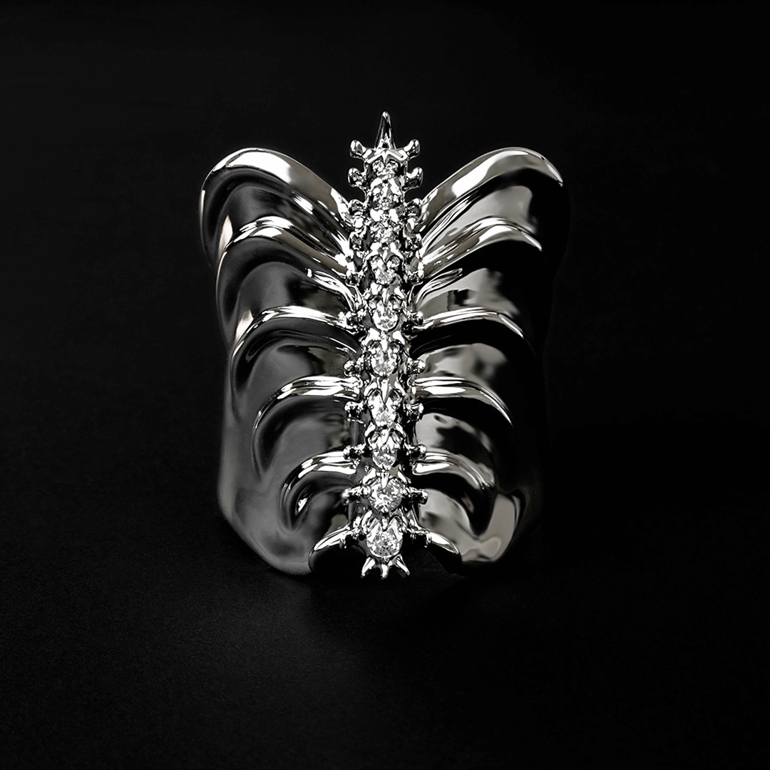 Command attention with the Gem Ribcage Cuff. Skeletal luxury meets couture gems in this red carpet-worthy arm piece.