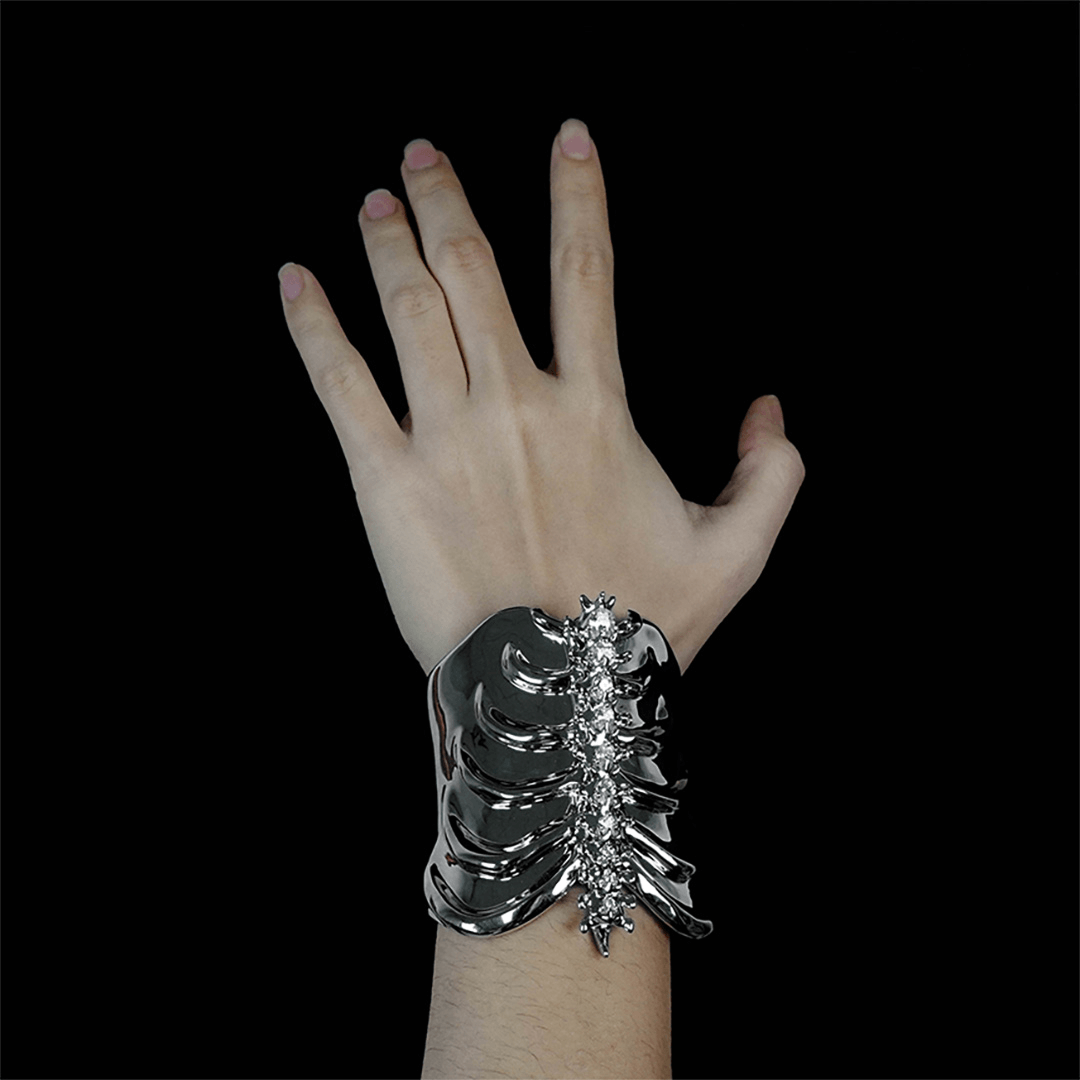 Command attention with the Gem Ribcage Cuff. Skeletal luxury meets couture gems in this red carpet-worthy arm piece.