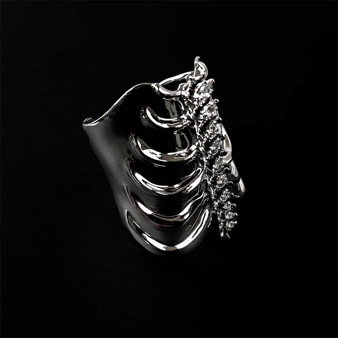 Command attention with the Gem Ribcage Cuff. Skeletal luxury meets couture gems in this red carpet-worthy arm piece.