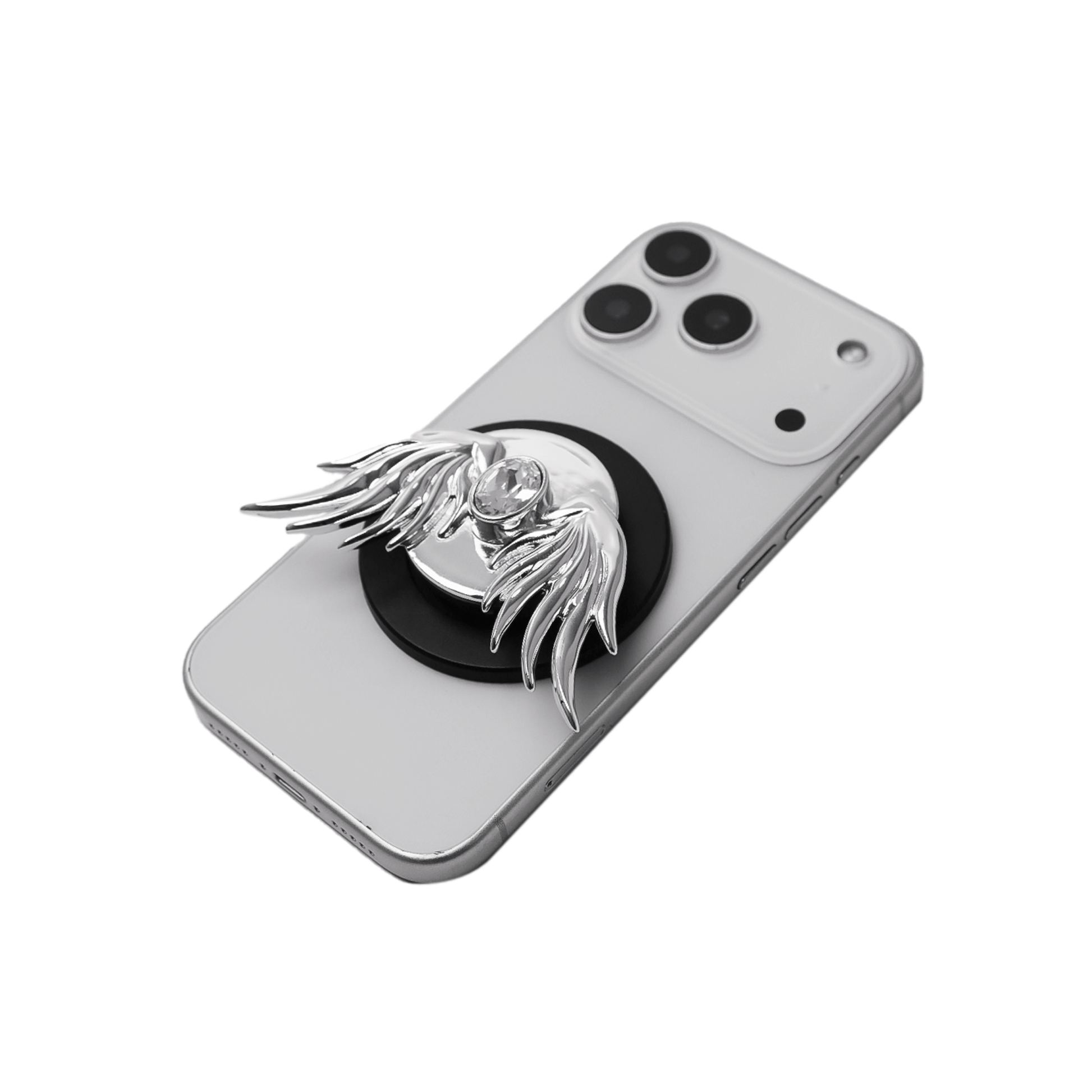 The Gem Angel Wings phone grip featuring intricately sculpted 3D wings with a sparkling central Swarovski crystal. Shown in both the reflective Silver Chrome and pure White finish options, attached to the back of a smartphone.