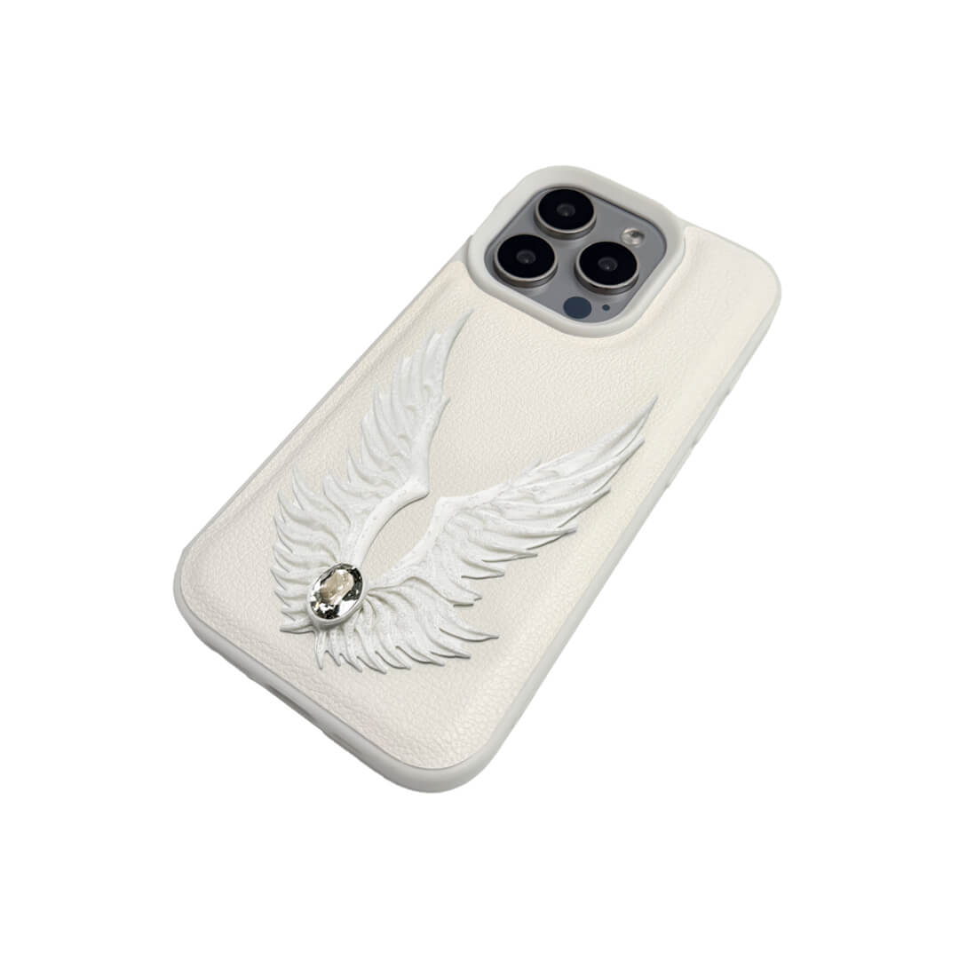 The Embroidered White Feather Wings iPhone Case featuring intricate white feather/wing embroidery and a central pearl, shown on both the Crystal Clear (Transparent) and White Leather Texture base options.