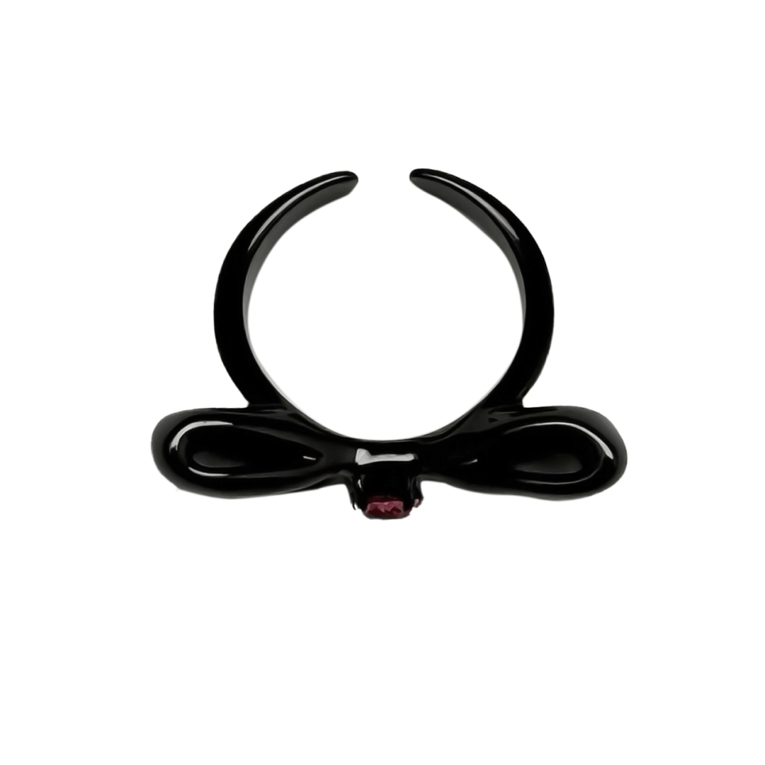 Elegant bow-shaped ring in silver and black with a pink Swarovski crystal at the center.