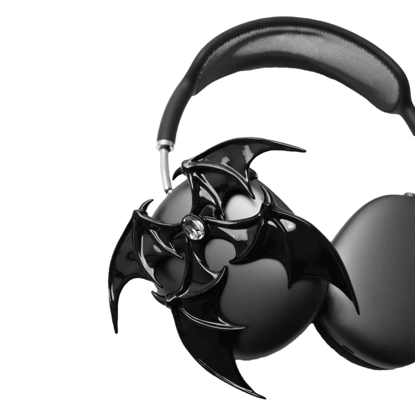 A high-fashion 3D attachment for AirPods Max featuring sharp, layered demon/bat wings with a central black Swarovski crystal on each ear cup. Available in two finishes: Reflective Silver Chrome and Sleek Nocturnal Black, shown in both single and pair configurations.