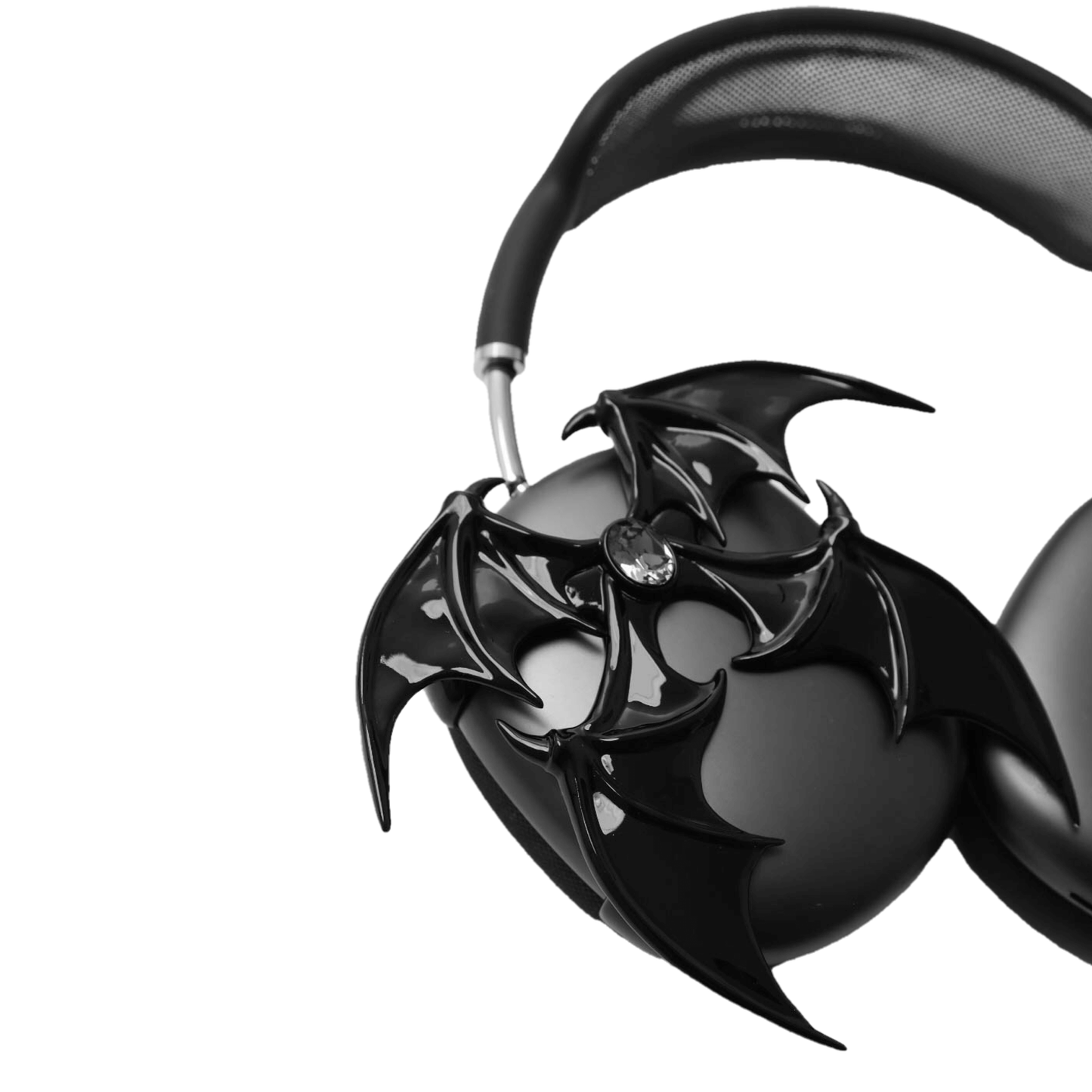 A high-fashion 3D attachment for AirPods Max featuring sharp, layered demon/bat wings with a central black Swarovski crystal on each ear cup. Available in two finishes: Reflective Silver Chrome and Sleek Nocturnal Black, shown in both single and pair configurations.