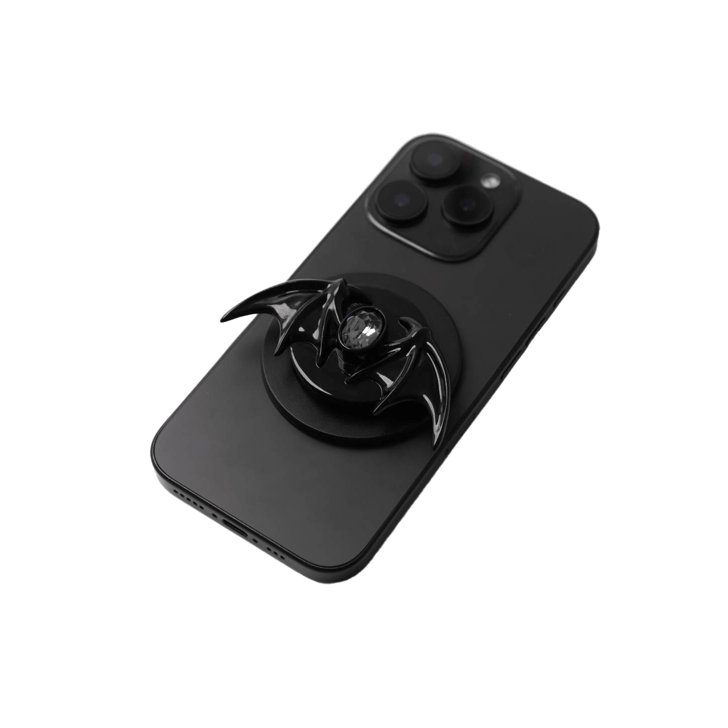 A 3D sculpted demon wing phone grip featuring a central black Swarovski crystal. The product is shown in two finish options: a reflective Silver Chrome that contrasts with the dark gem, and a Sleek Black finish for a full monochromatic look. It is designed to function as both a secure hand grip and a desktop stand.