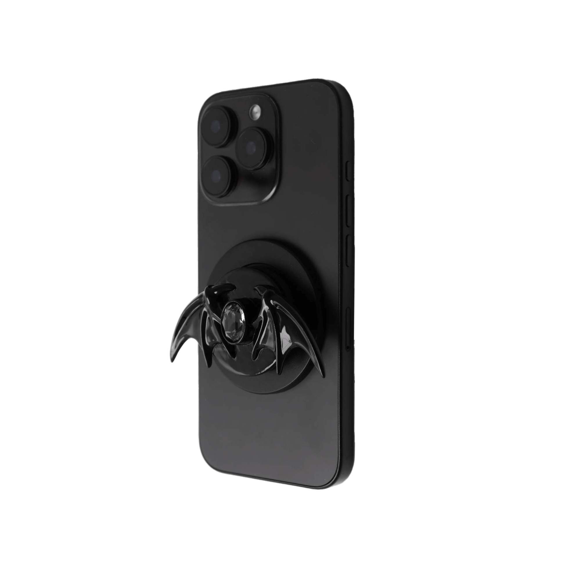 A 3D sculpted demon wing phone grip featuring a central black Swarovski crystal. The product is shown in two finish options: a reflective Silver Chrome that contrasts with the dark gem, and a Sleek Black finish for a full monochromatic look. It is designed to function as both a secure hand grip and a desktop stand.