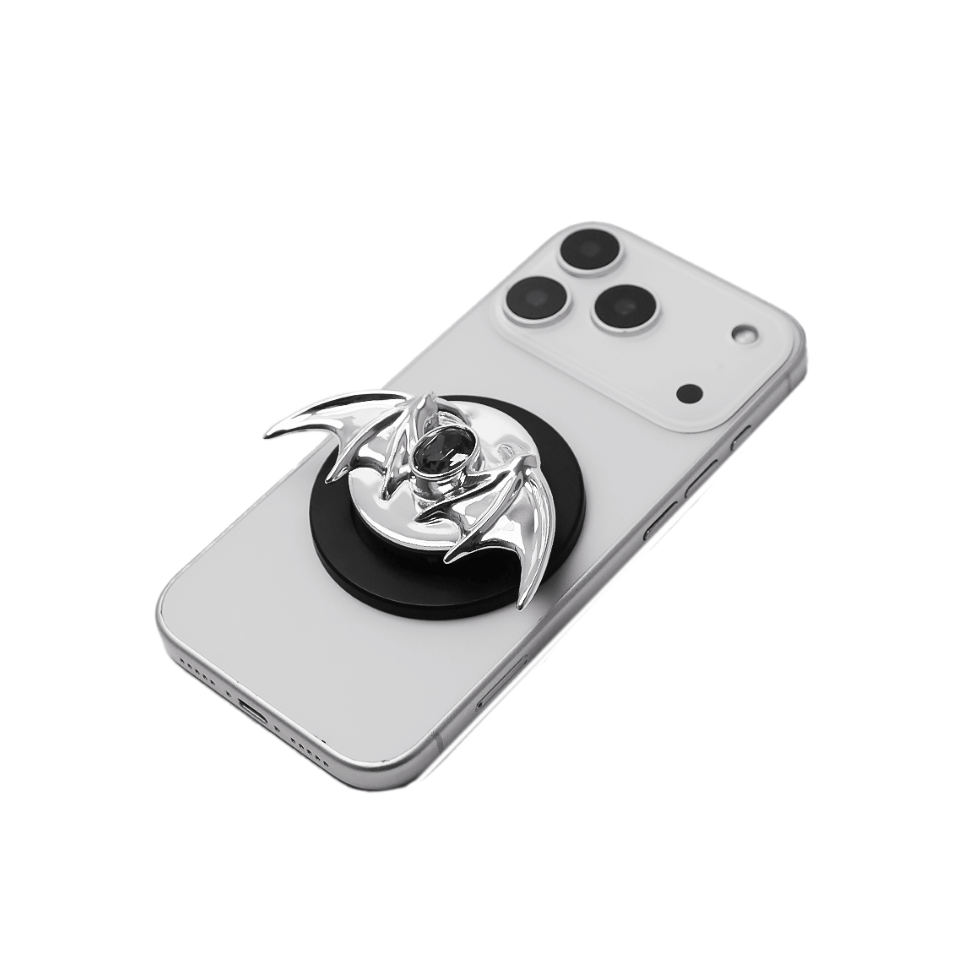 A 3D sculpted demon wing phone grip featuring a central black Swarovski crystal. The product is shown in two finish options: a reflective Silver Chrome that contrasts with the dark gem, and a Sleek Black finish for a full monochromatic look. It is designed to function as both a secure hand grip and a desktop stand.