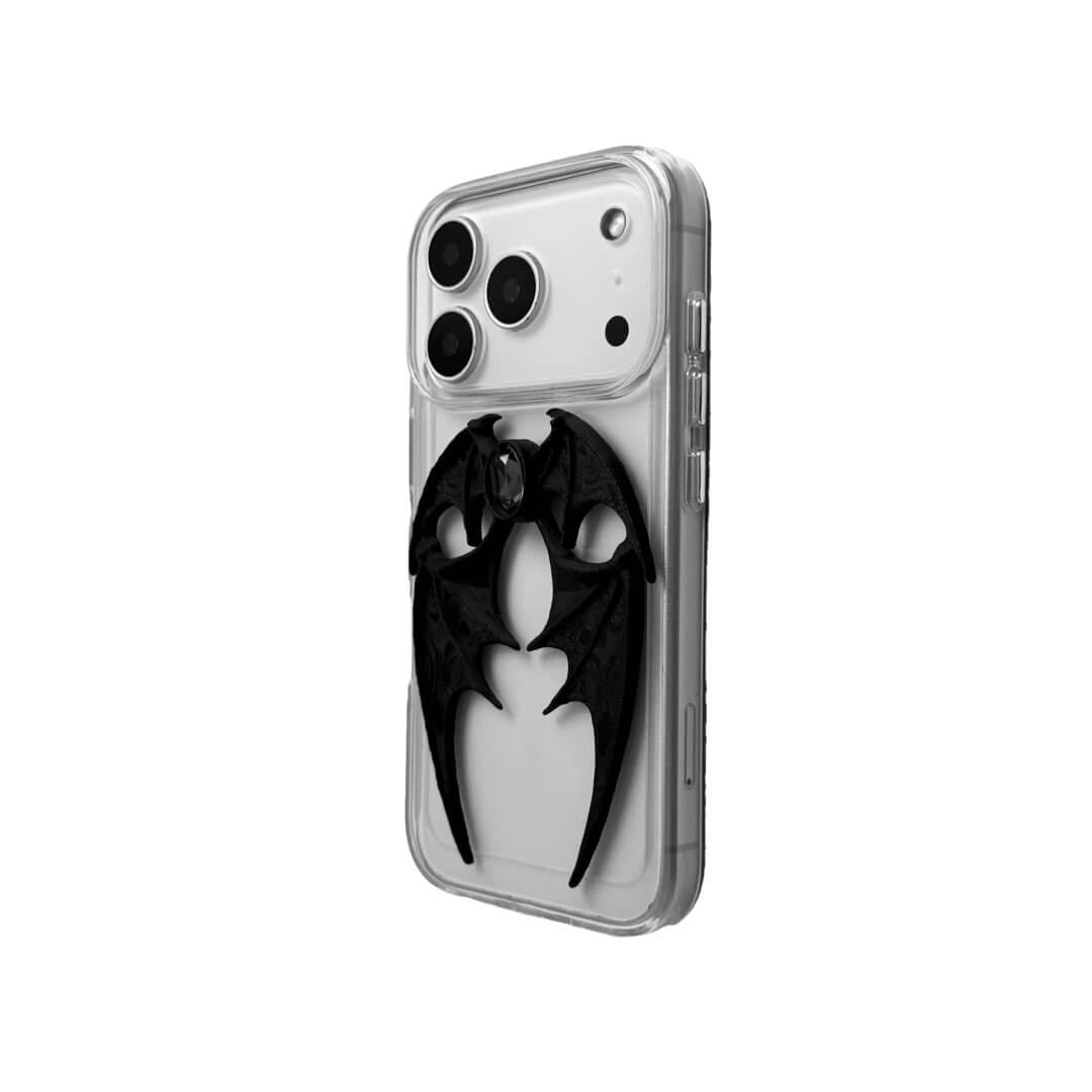 A high-fashion iPhone case featuring a pair of 3D-printed demon wings curving around a central sparkling gem, all in a natural matte black finish. Available in two variations: a minimalist Clear Transparent base and a luxurious Black Leather textured base, showcasing the intricate and edgy sculptural design.