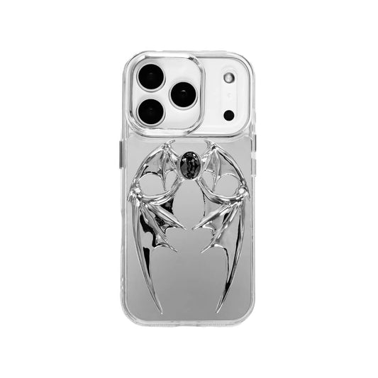 The Gem Demon Wings iPhone Case featuring 3D sculpted silver metallic bat-style wings with a central rhinestone. Shown with both White and Black gem options, available on Silver, Transparent, and Black case bases.