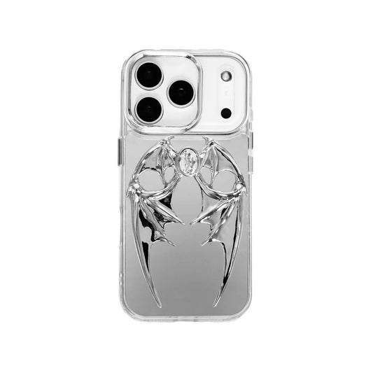 The Gem Demon Wings iPhone Case featuring 3D sculpted silver metallic bat-style wings with a central rhinestone. Shown with both White and Black gem options, available on Silver, Transparent, and Black case bases.