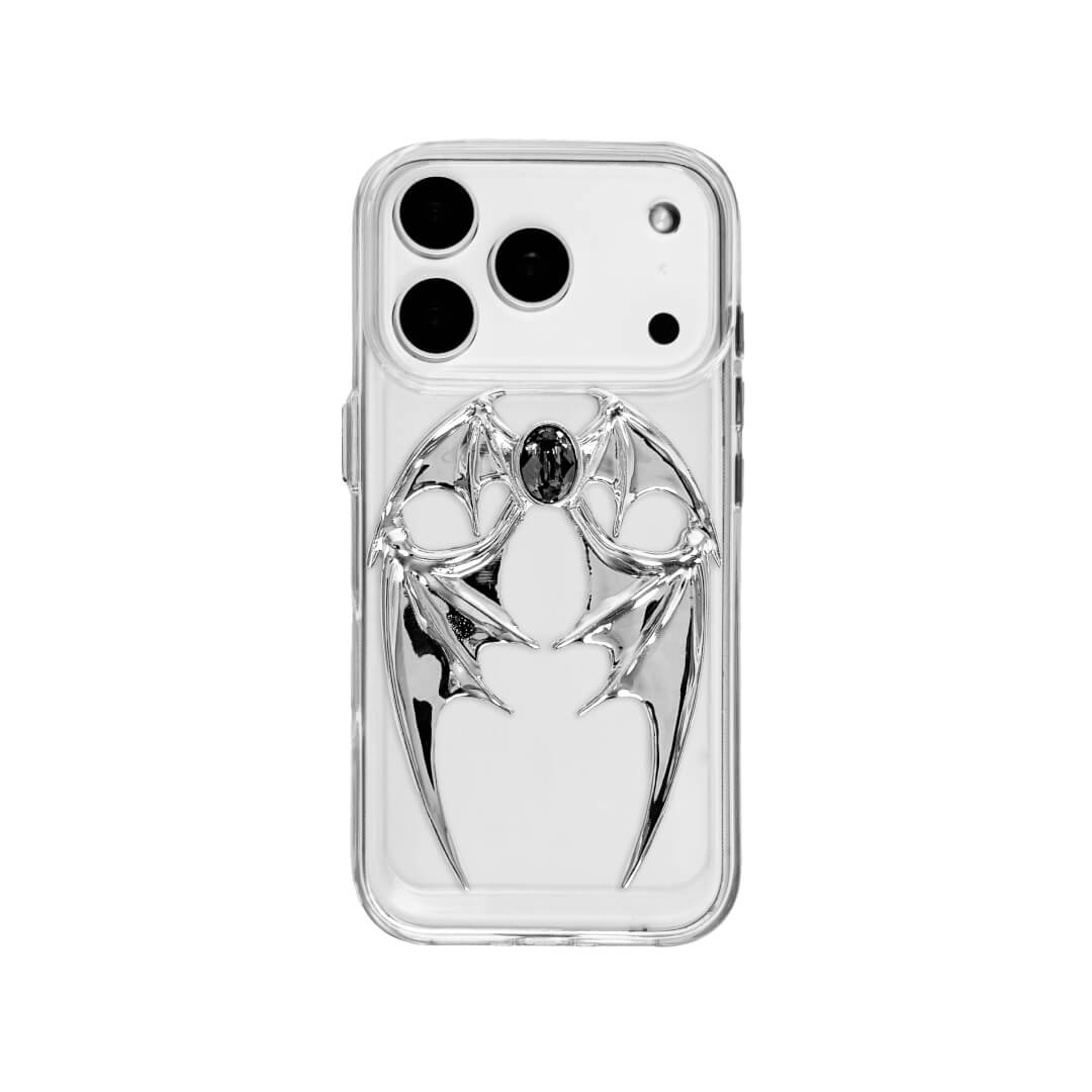The Gem Demon Wings iPhone Case featuring 3D sculpted silver metallic bat-style wings with a central rhinestone. Shown with both White and Black gem options, available on Silver, Transparent, and Black case bases.