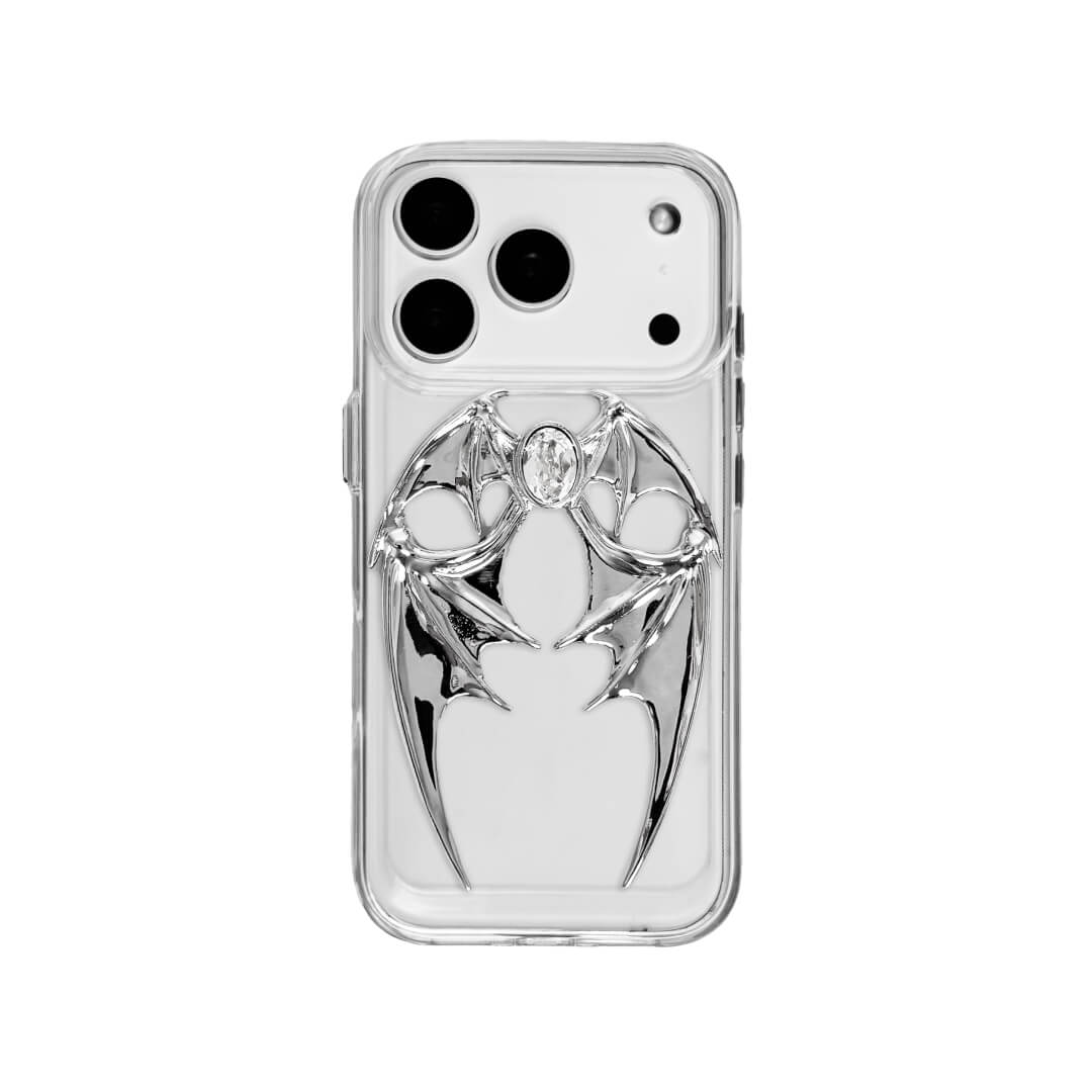 The Gem Demon Wings iPhone Case featuring 3D sculpted silver metallic bat-style wings with a central rhinestone. Shown with both White and Black gem options, available on Silver, Transparent, and Black case bases.