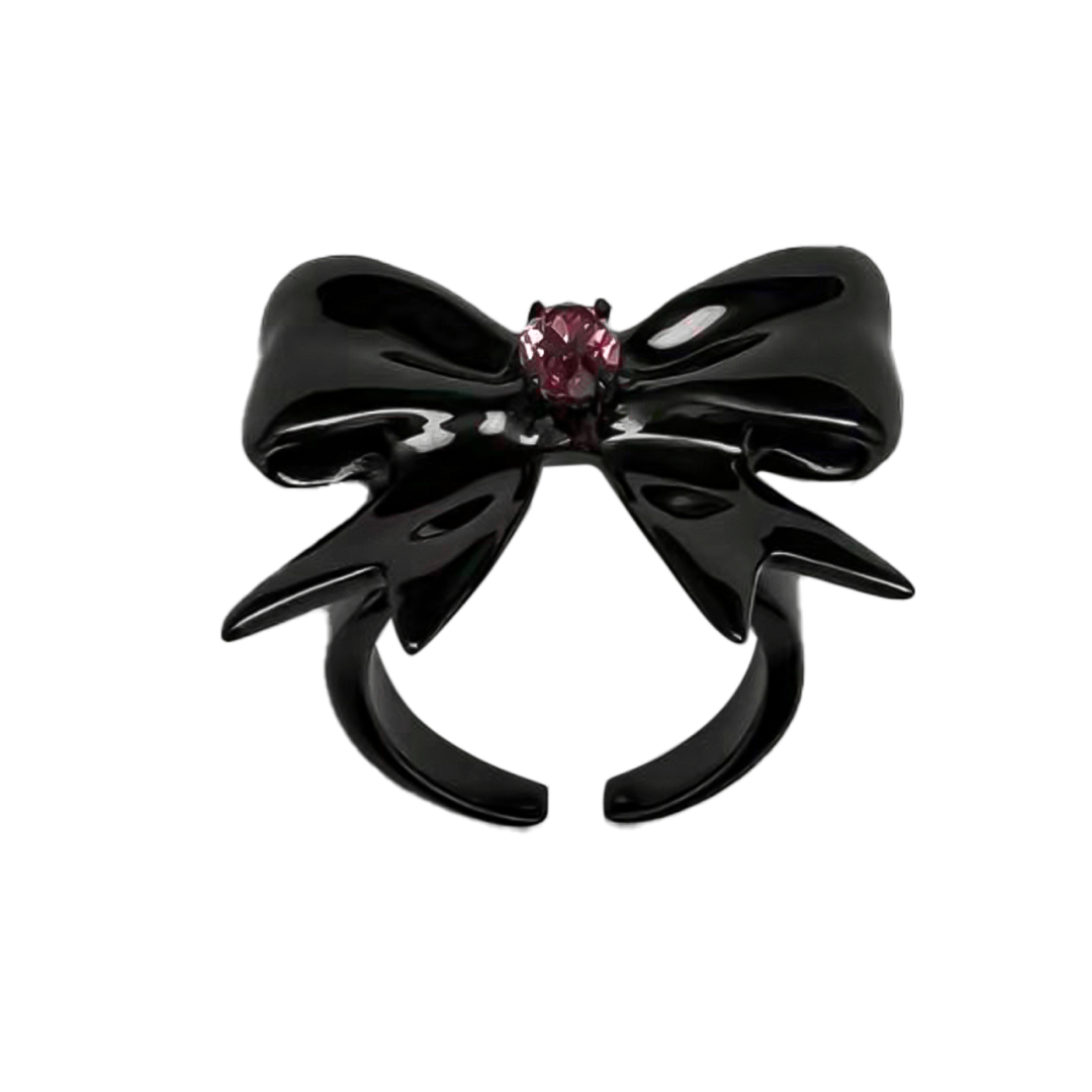 Stylish ribbon-shaped ring in silver and black with a pink Swarovski crystal accent.