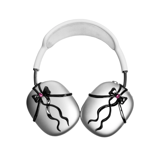 AirPods Max cover with sculpted metallic black/silver shells, adorned with a flowing 3D ribbon design and highlighted by a shimmering Pink Gem (Swarovski Crystal), creating a luxurious, statement look.