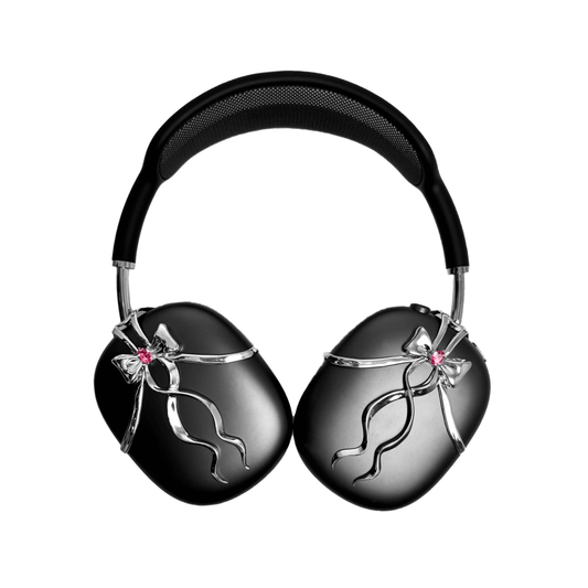 AirPods Max cover with sculpted metallic black/silver shells, adorned with a flowing 3D ribbon design and highlighted by a shimmering Pink Gem (Swarovski Crystal), creating a luxurious, statement look.