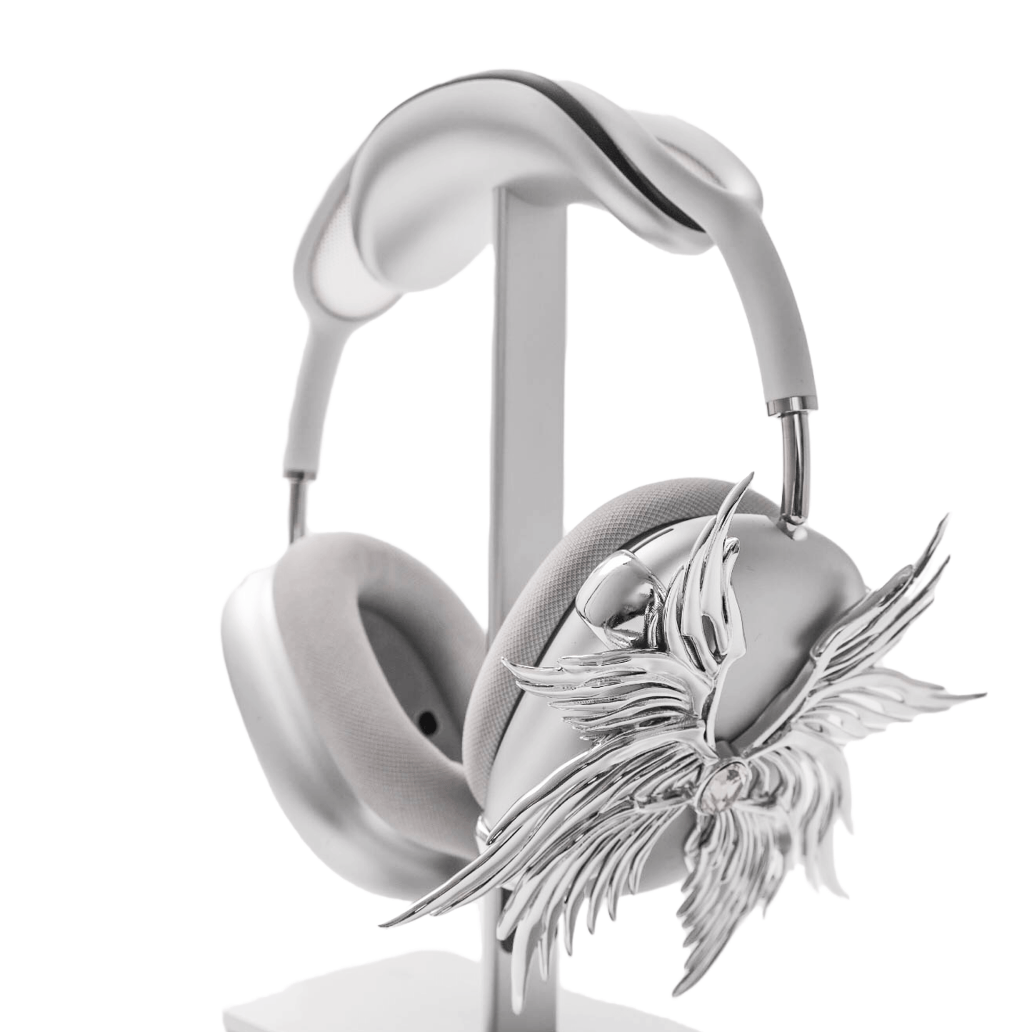 A high-fashion 3D attachment for AirPods Max headphones featuring layered, symmetrical Seraphim angel wings with a central white Swarovski crystal on each ear cup. Shown in two finish options: Reflective Silver Chrome and Matte Ethereal White.