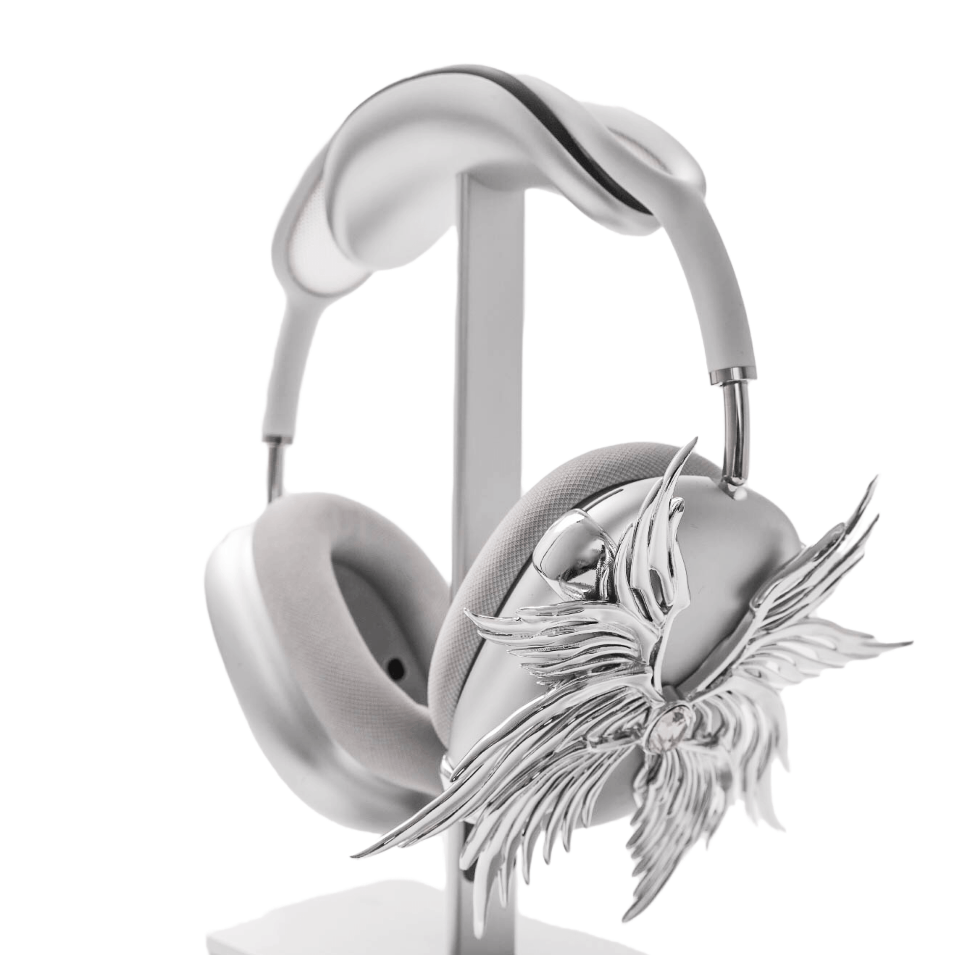 A high-fashion 3D attachment for AirPods Max headphones featuring layered, symmetrical Seraphim angel wings with a central white Swarovski crystal on each ear cup. Shown in two finish options: Reflective Silver Chrome and Matte Ethereal White.