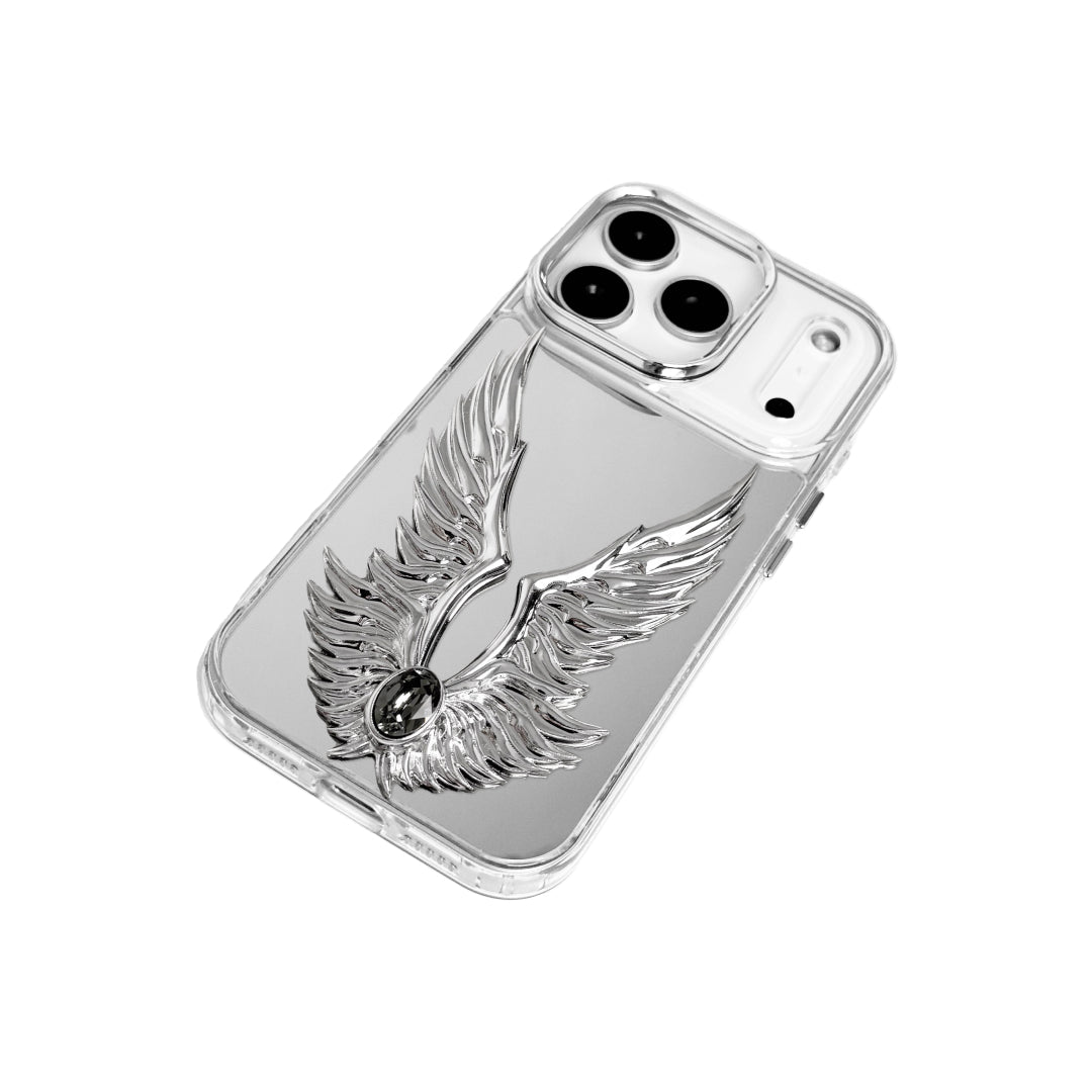 The Gem Silver Angel Wings iPhone Case featuring symmetrical 3D sculpted silver wings with a central rhinestone. Shown with both White and Black gem options, available on Silver, Transparent, and Black case bases.